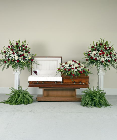 Red and white floral suite with casket spray, urns, and lid pillow for sympathy.